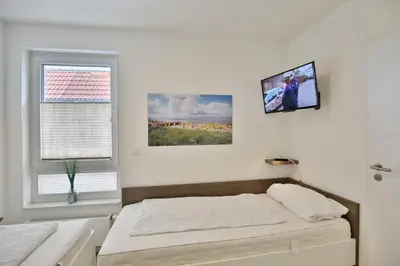 Ein Bett oder Betten in einem Zimmer der Unterkunft Dünenweg 37, DW2