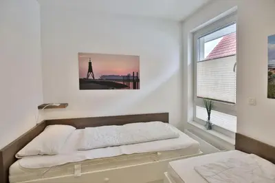 Ein Bett oder Betten in einem Zimmer der Unterkunft Dünenweg 37, DW2