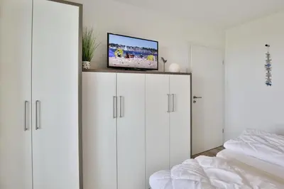 Ein Bett oder Betten in einem Zimmer der Unterkunft Dünenweg 37, DW2