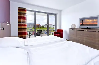 Ein Bett oder Betten in einem Zimmer der Unterkunft Residenz am Yachthafen, RY9