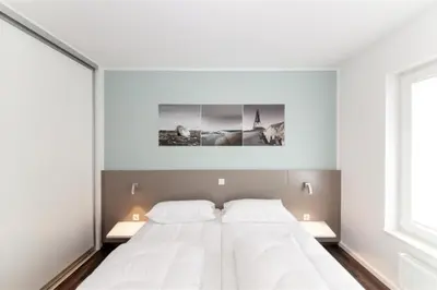 Ein Bett oder Betten in einem Zimmer der Unterkunft Duhner Brandung, B8