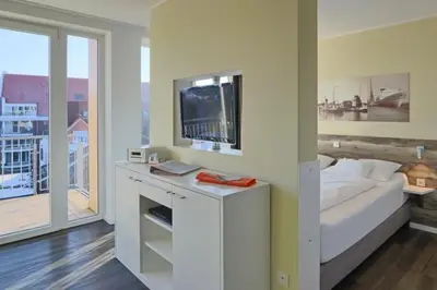 Ein Bett oder Betten in einem Zimmer der Unterkunft Duhner Strandhus, S303