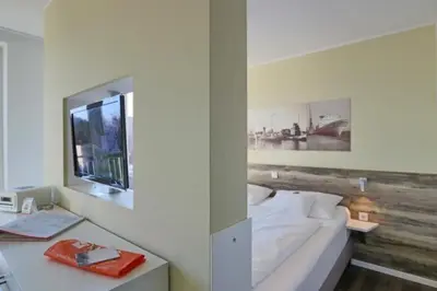 Ein Bett oder Betten in einem Zimmer der Unterkunft Duhner Strandhus, S303