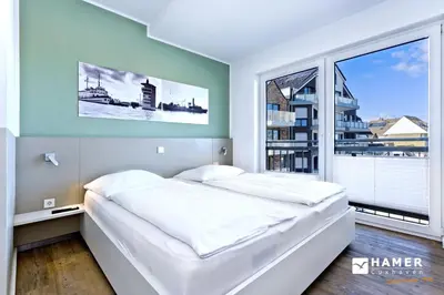 Ein Bett oder Betten in einem Zimmer der Unterkunft Duhner Brandung, B12