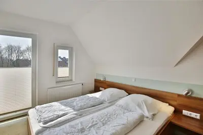 Ein Bett oder Betten in einem Zimmer der Unterkunft Wattwagen, RW5