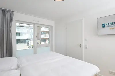Ein Bett oder Betten in einem Zimmer der Unterkunft Nordstrand, N104