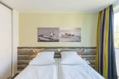 Ein Bett oder Betten in einem Zimmer der Unterkunft Duhner Strandhus, S210
