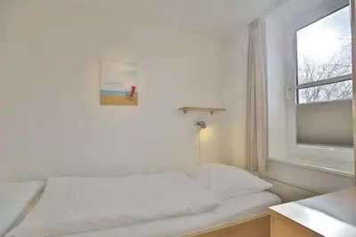 Ein Bett oder Betten in einem Zimmer der Unterkunft Hohe Worth, H312