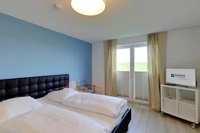 Ein Bett oder Betten in einem Zimmer der Unterkunft Nordseeblick, NB2