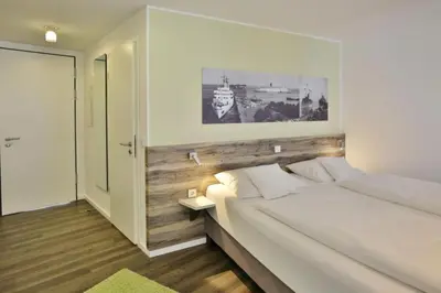 Ein Bett oder Betten in einem Zimmer der Unterkunft Duhner Strandhus, S112
