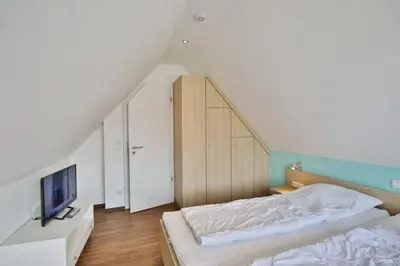 Ein Bett oder Betten in einem Zimmer der Unterkunft Wattwagen, RW6