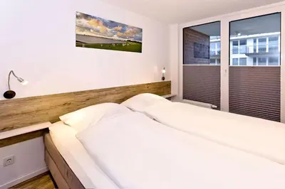 Ein Bett oder Betten in einem Zimmer der Unterkunft Hohe Worth, H205