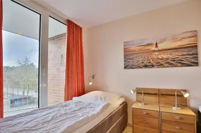 Ein Bett oder Betten in einem Zimmer der Unterkunft Hohe Worth, H306