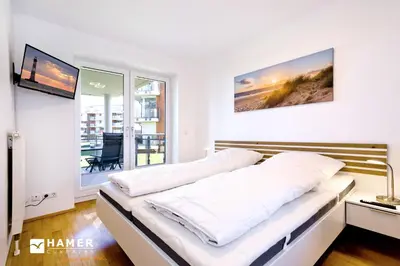 Ein Bett oder Betten in einem Zimmer der Unterkunft Strandpalais, SP405