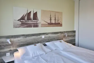 Ein Bett oder Betten in einem Zimmer der Unterkunft Duhner Strandhus, S201