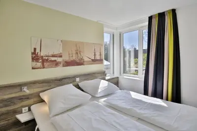 Ein Bett oder Betten in einem Zimmer der Unterkunft Duhner Strandhus, S113