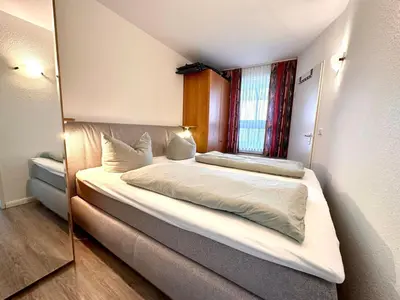 Ein Bett oder Betten in einem Zimmer der Unterkunft Ferienwohnung De Kiewitt 207