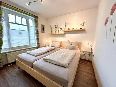 Ein Bett oder Betten in einem Zimmer der Unterkunft Ferienwohnung De Ööster