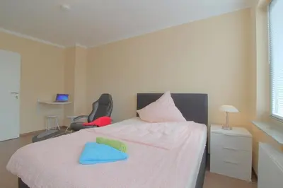 Ein Bett oder Betten in einem Zimmer der Unterkunft Gästehaus Dorum 01