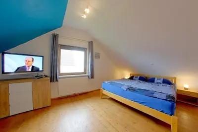 Ein Bett oder Betten in einem Zimmer der Unterkunft KW21a Ferienhaus Silbermöwe
