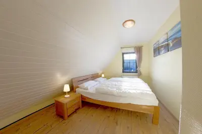 Ein Bett oder Betten in einem Zimmer der Unterkunft KW19 Ferienhaus Kormoranweg