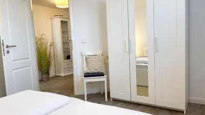 Ein Bett oder Betten in einem Zimmer der Unterkunft Kapitänshaus FeWo 7
