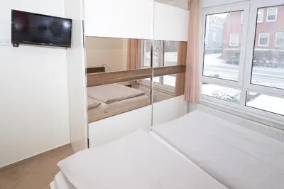 Ein Bett oder Betten in einem Zimmer der Unterkunft Duhner Dorfvilla, FeWo 1