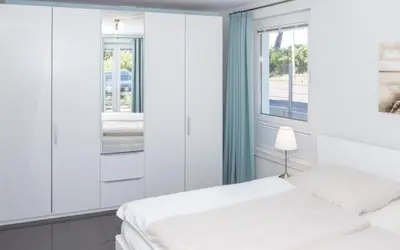 Ein Bett oder Betten in einem Zimmer der Unterkunft Düne 1 FeWo4 - Duene4u