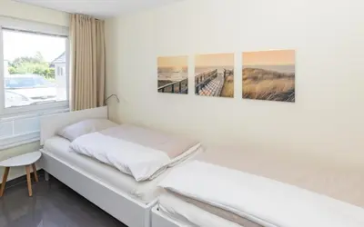 Ein Bett oder Betten in einem Zimmer der Unterkunft Düne 1 FeWo4 - Duene4u