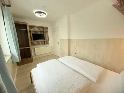Ein Bett oder Betten in einem Zimmer der Unterkunft Kenny & Henry Familienzimmer