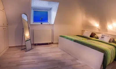 Ein Bett oder Betten in einem Zimmer der Unterkunft Die kleine Cuxperle FeWo 2