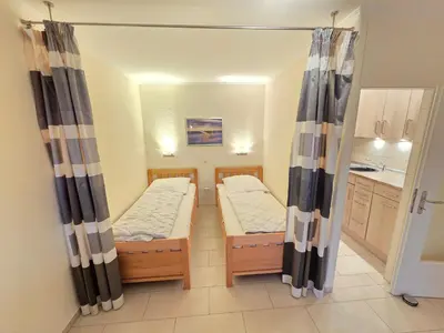 Ein Bett oder Betten in einem Zimmer der Unterkunft Strandhochhaus Wohnung E3