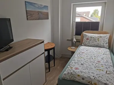 Ein Bett oder Betten in einem Zimmer der Unterkunft Strandhaus Deichvoigt