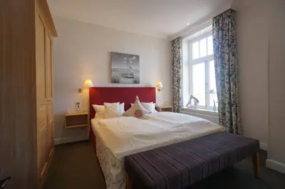Ein Bett oder Betten in einem Zimmer der Unterkunft Aparthotel Am Meer