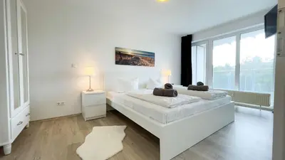 Ein Bett oder Betten in einem Zimmer der Unterkunft Strandhaus Nordseebrandung Fewo A4.2