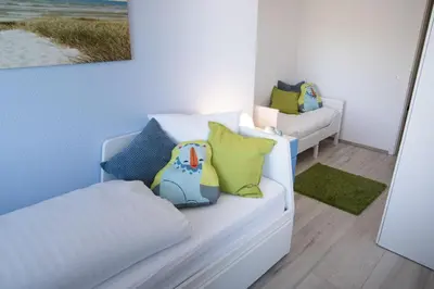 Ein Bett oder Betten in einem Zimmer der Unterkunft Strandhaus Nordseebrandung Fewo B3.4
