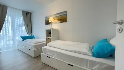 Ein Bett oder Betten in einem Zimmer der Unterkunft Strandhaus Nordseebrandung Fewo B2.1