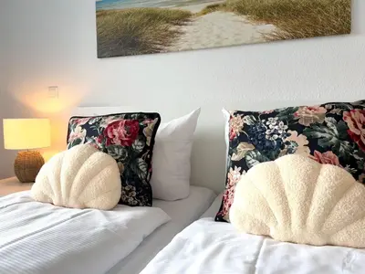 Ein Bett oder Betten in einem Zimmer der Unterkunft Strandhaus Nordseebrandung Fewo A2.1