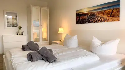 Ein Bett oder Betten in einem Zimmer der Unterkunft Strandhaus Nordseebrandung Fewo B1.2