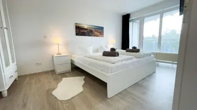 Ein Bett oder Betten in einem Zimmer der Unterkunft Strandhaus Nordseebrandung Fewo B3.2