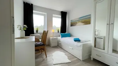 Ein Bett oder Betten in einem Zimmer der Unterkunft Strandhaus Nordseebrandung Fewo A4.3