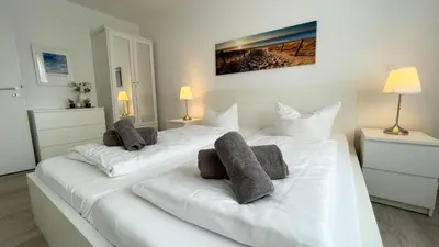 Ein Bett oder Betten in einem Zimmer der Unterkunft Strandhaus Nordseebrandung Fewo B3.1