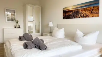 Ein Bett oder Betten in einem Zimmer der Unterkunft Strandhaus Nordseebrandung Fewo A1.2