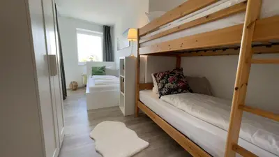 Ein Bett oder Betten in einem Zimmer der Unterkunft Strandhaus Nordseebrandung Fewo D1.4