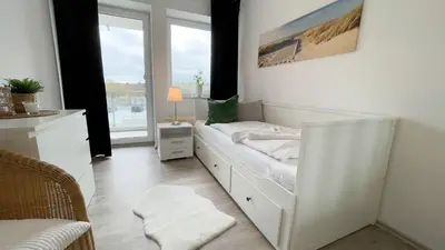 Ein Bett oder Betten in einem Zimmer der Unterkunft Strandhaus Nordseebrandung Fewo D1.5
