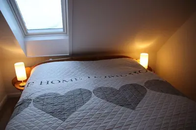 Ein Bett oder Betten in einem Zimmer der Unterkunft Ferienwohnung Möwenschiss - Haus Bake