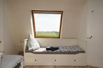 Ein Bett oder Betten in einem Zimmer der Unterkunft Ferienhaus Kiebitz mit Sauna