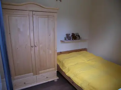 Ein Bett oder Betten in einem Zimmer der Unterkunft Ferienhaus Regenbogen