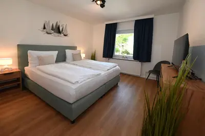 Ein Bett oder Betten in einem Zimmer der Unterkunft Strandhotel Salty