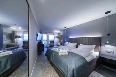 Ein Bett oder Betten in einem Zimmer der Unterkunft Strandhotel Duhnen